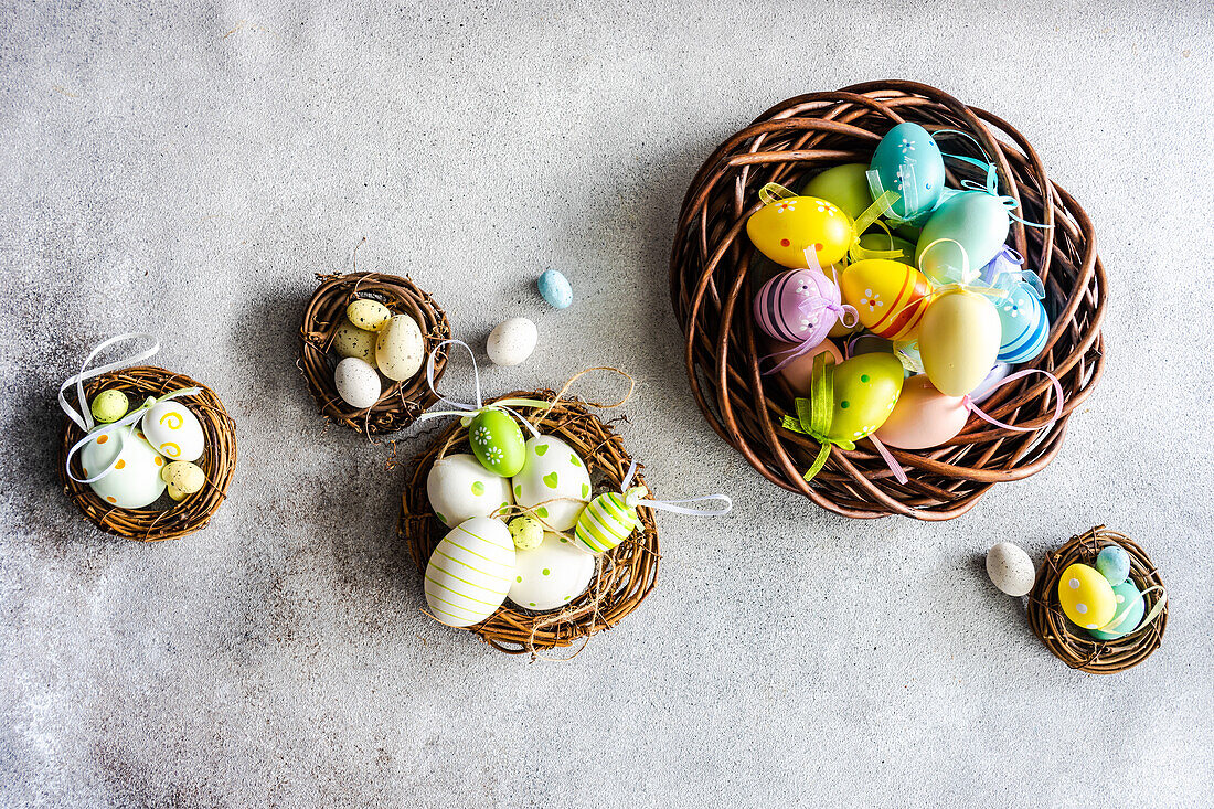 Top view easter holiday card with wreathes full of multicolor eggs on concrete background