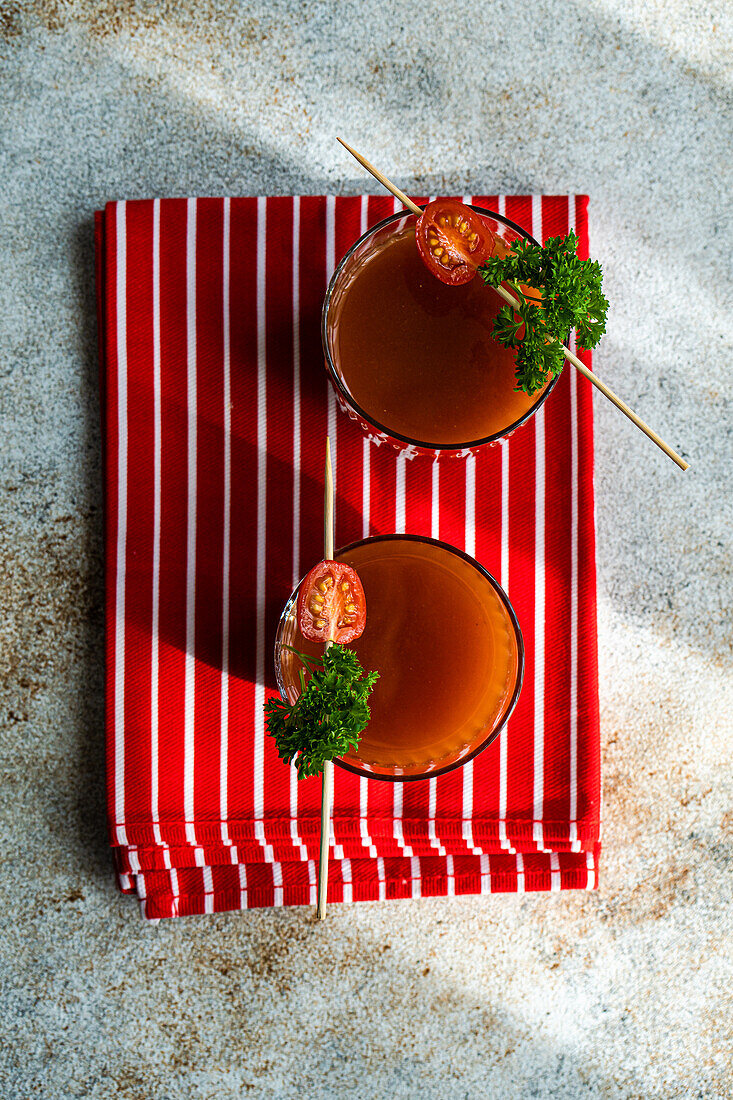 Bloody Mary or Caesar cocktail drink served in the glass on concrete background