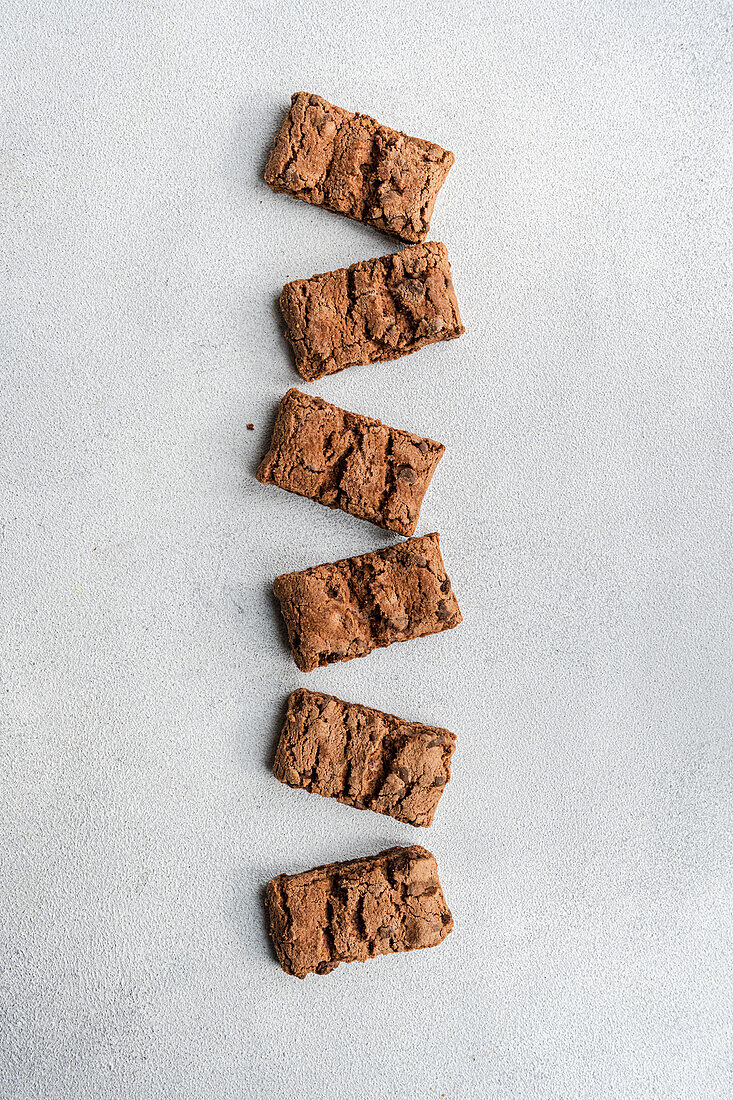 Top view of fresh baked chocolate cookies on concrete background