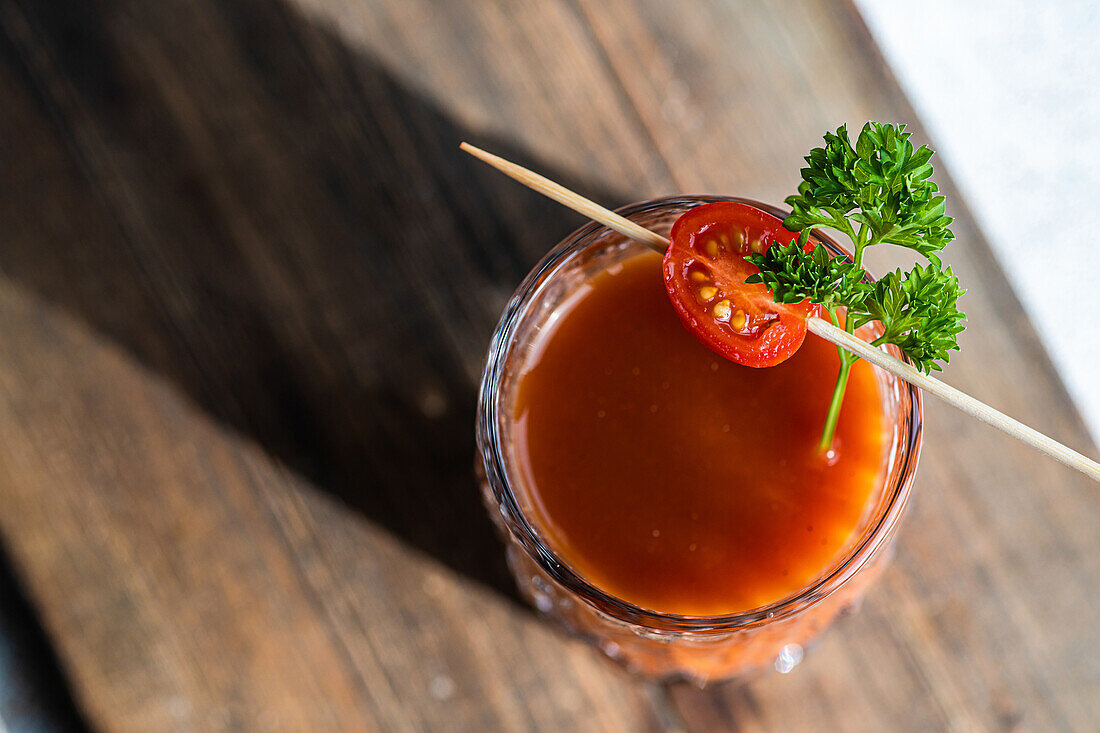 Bloody Mary or Caesar cocktail drink served in the glass on concrete background