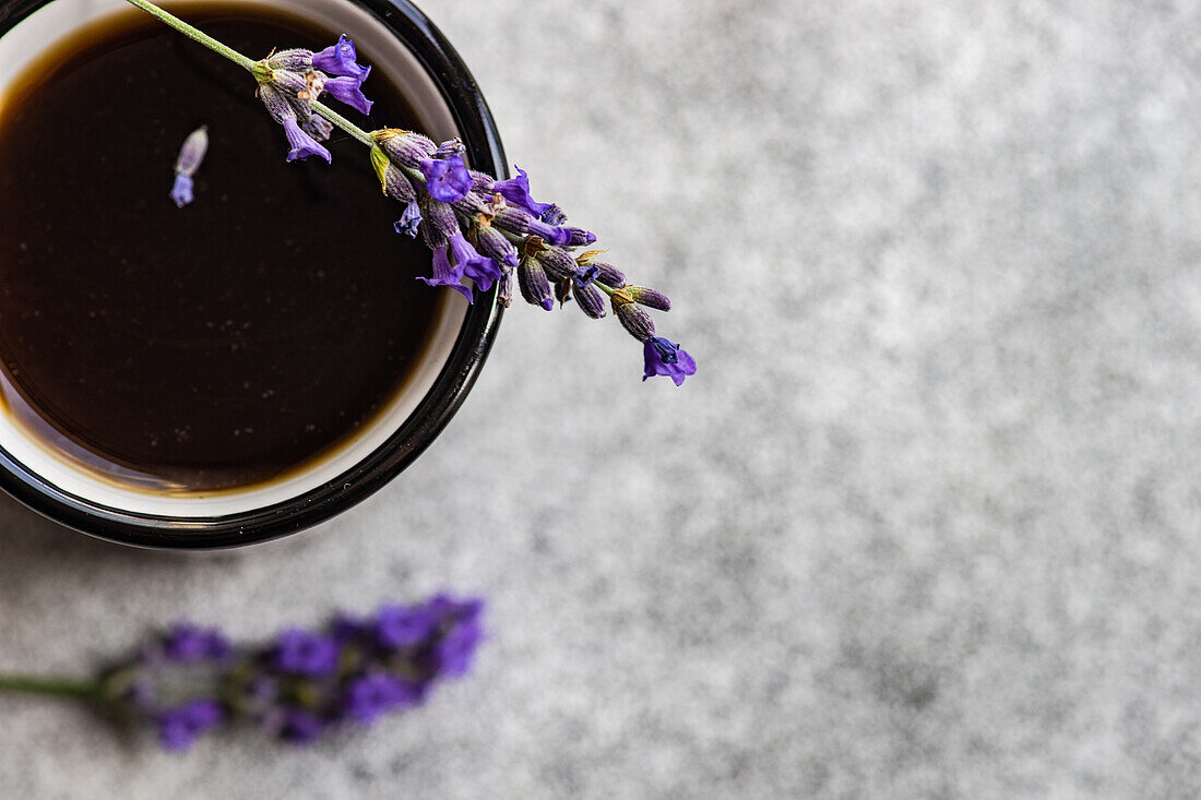 Top view of espresso coffee with lavender on concrete background
