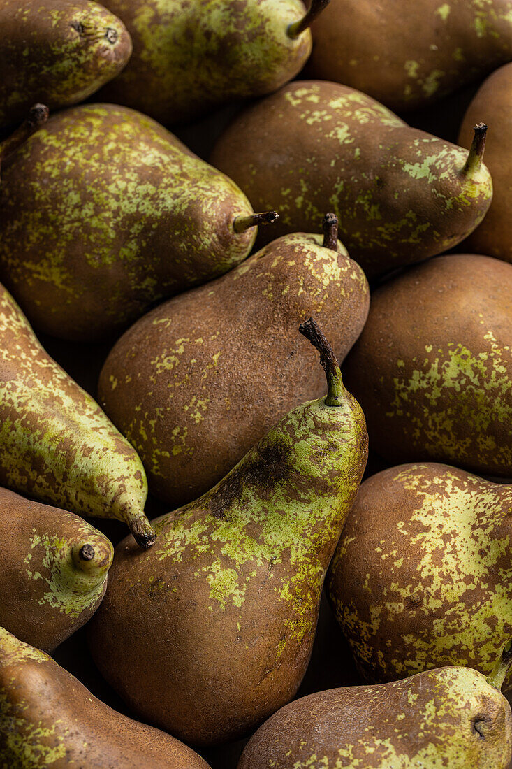 Top view full frame background of appetizing fresh green pears with brown spots placed together