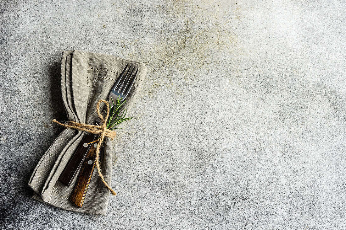 From above minimalistic cutlery set on the concrete background