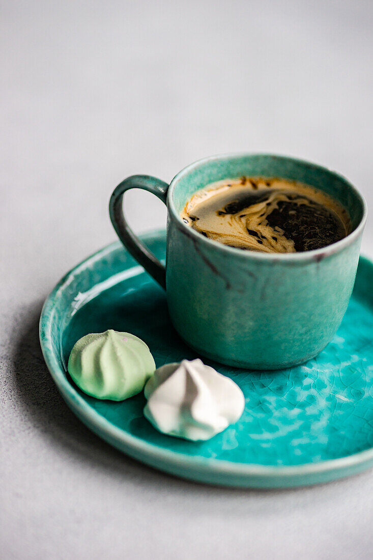 von oben Tasse Kaffee mit Mini-Bonbons auf Betontisch