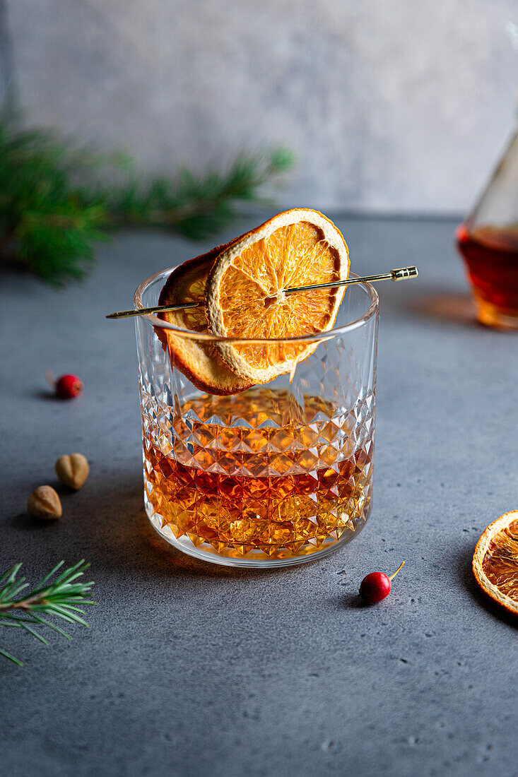 Composition of cold icy liquor garnished with orange slice and placed on table