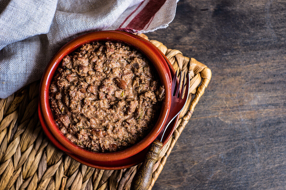 Famous Georgian Lobio with walnuts dish served in ceramic bowl on wooden table