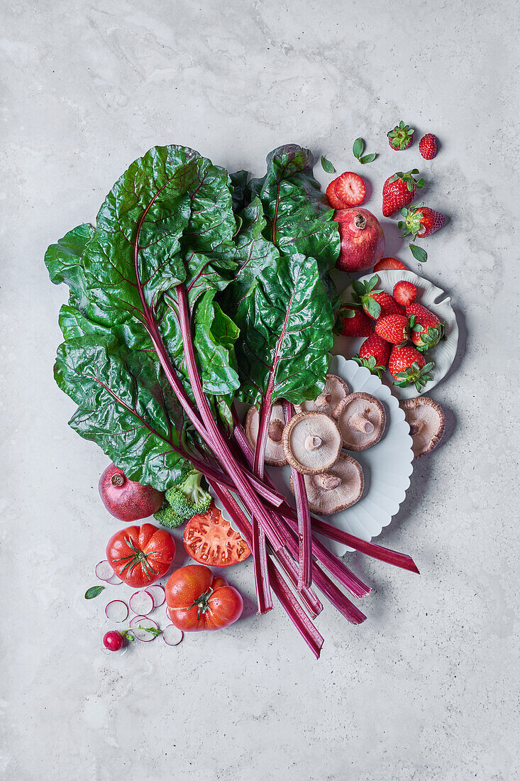 Top view of different fresh vegetables and fruit on a white table