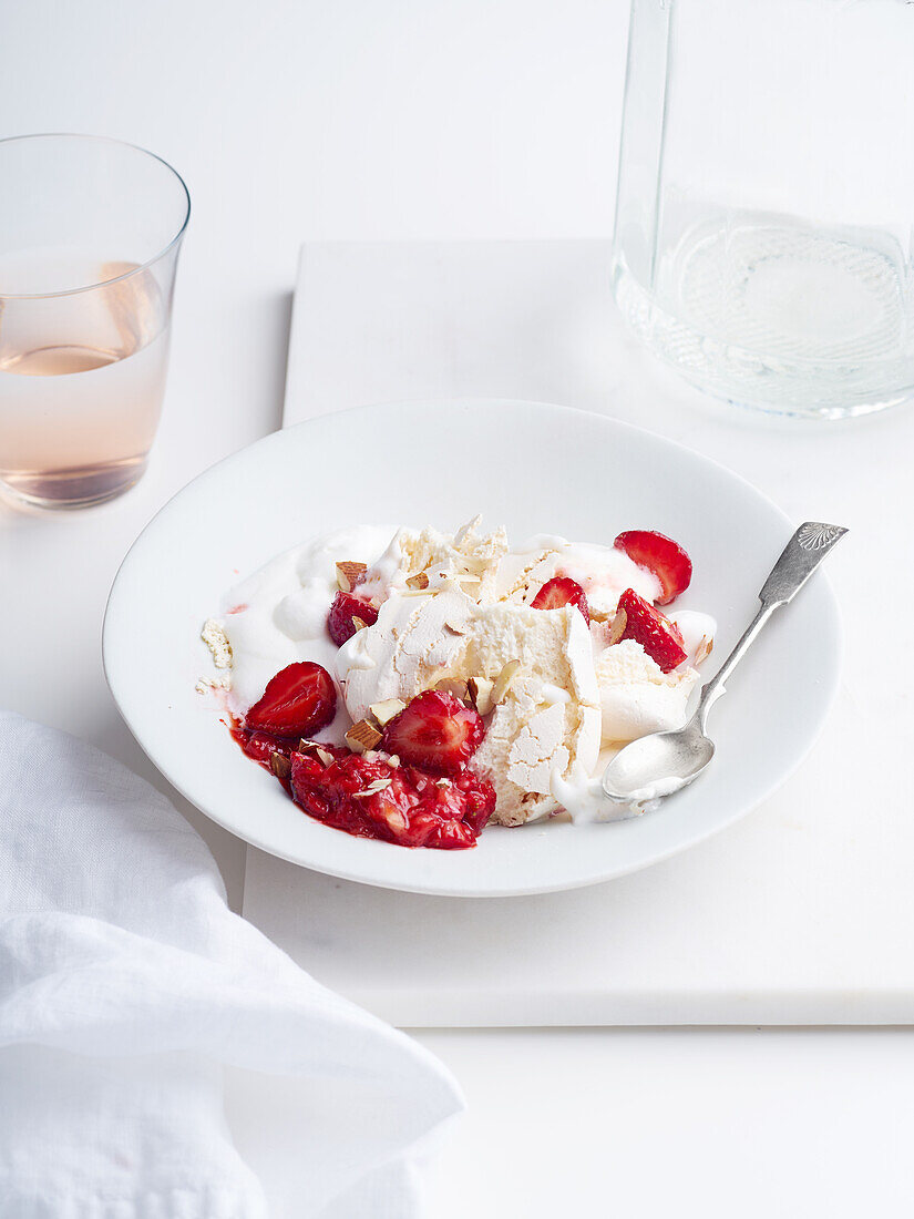Dessert with berries, meringue and whipped cream. Eton's mess with strawberries, sweet treat with summer mood