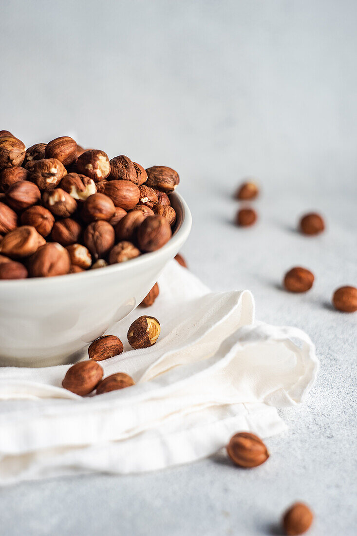 Bowl with organic hazelnuts on the napkin