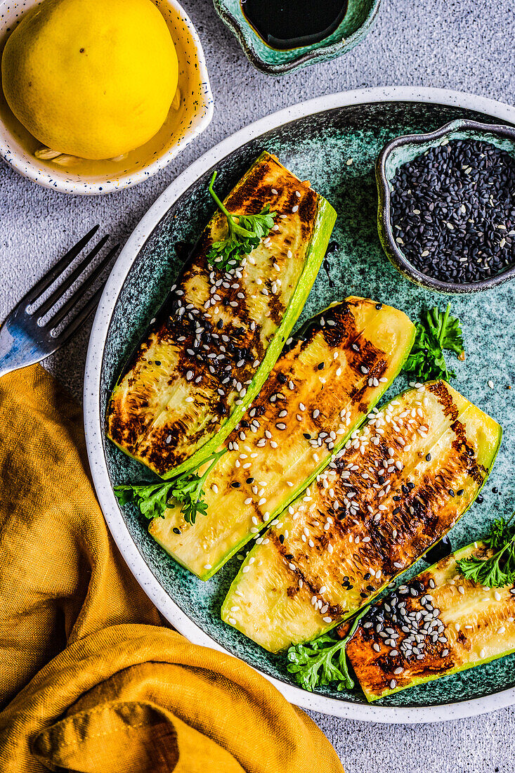 From above roasted on grill zucchini slices served on the plate