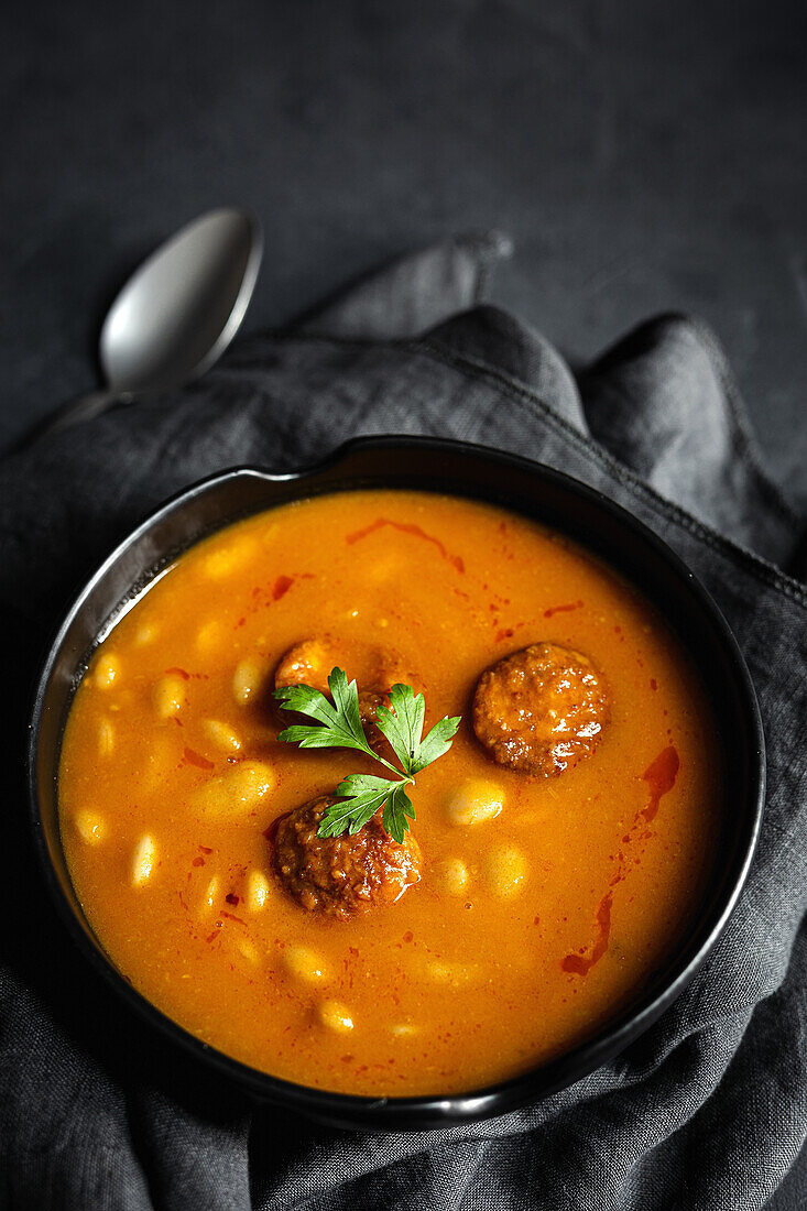 Delicious plate of beans with chorizo seen from above