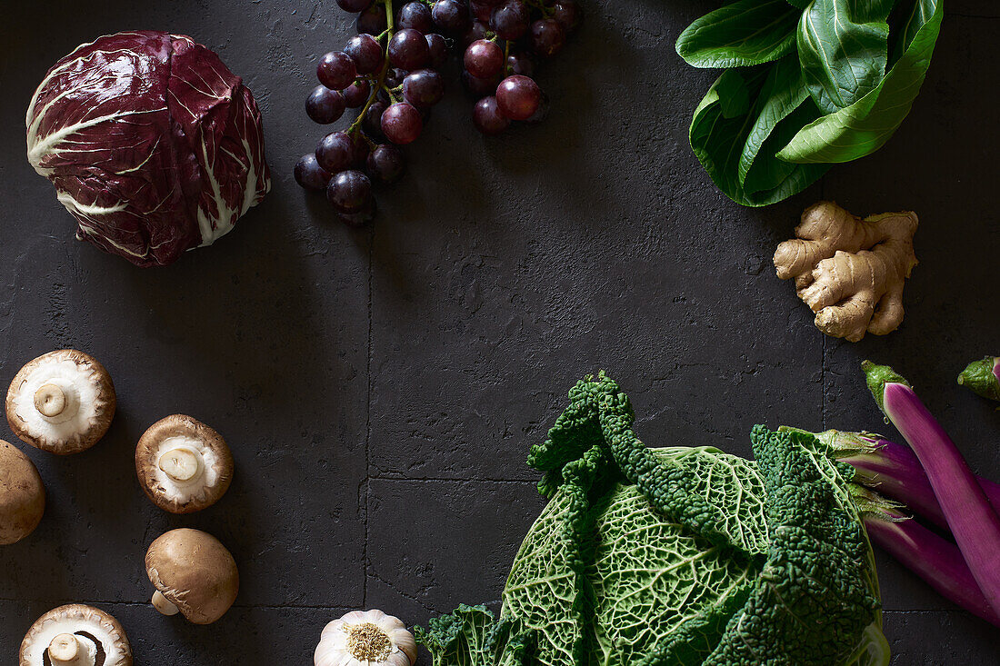 From above still life with fresh fruits and vegetables on dark background