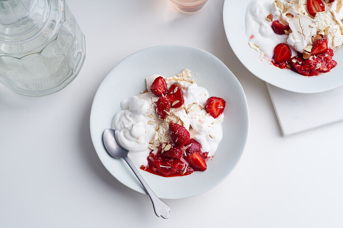 Top view image of a dessert with berries, meringue and whipped cream. Eton's mess with strawberries, sweet treat with summer mood