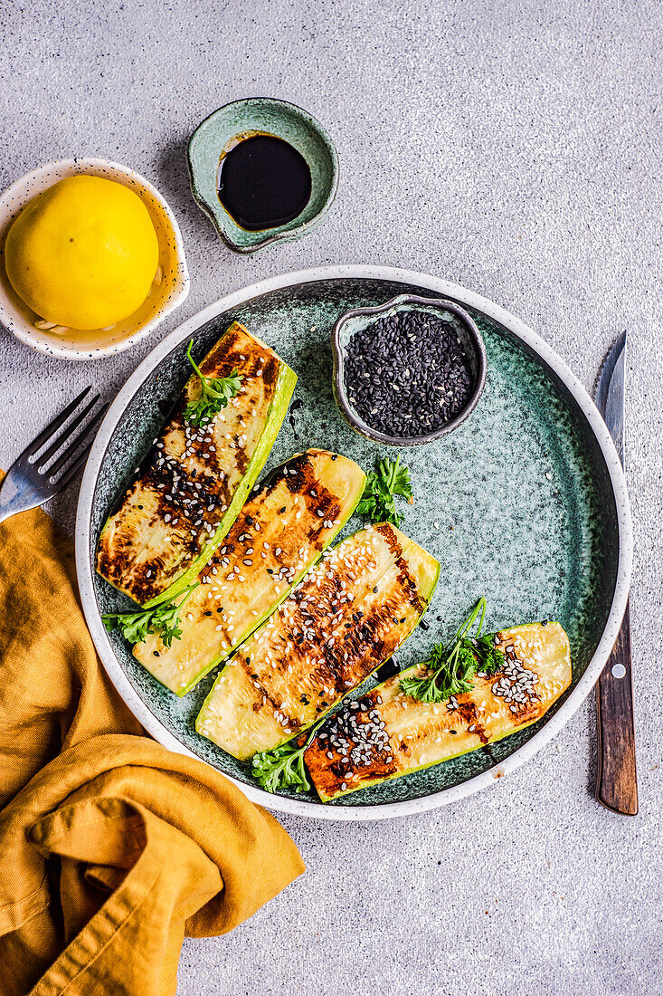 From above roasted on grill zucchini slices served on the plate