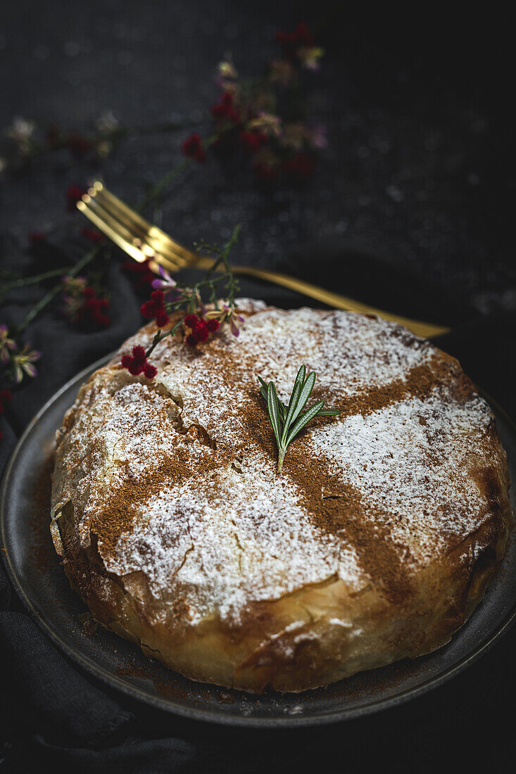 From above of appetizing bastilla with aromatic spices on table near flower sprig during Ramadan holidays