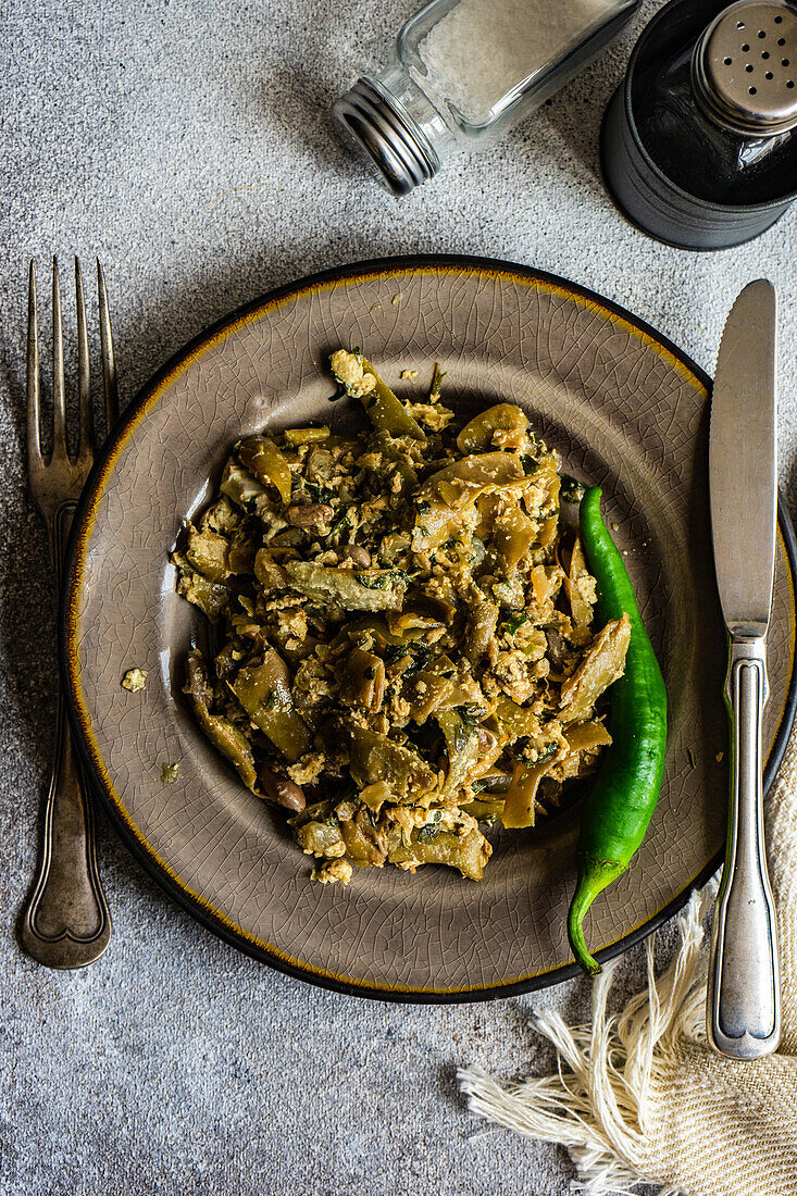 Traditional georgian summer lobio dish with french beans with eggs and herbs on stone background with copy space