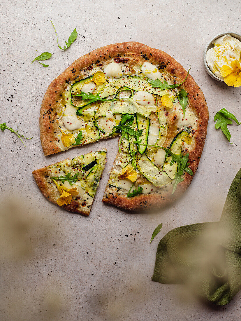 Top view of tasty pizza with arugula leaves on melted mozzarella cheese with black sesame seeds