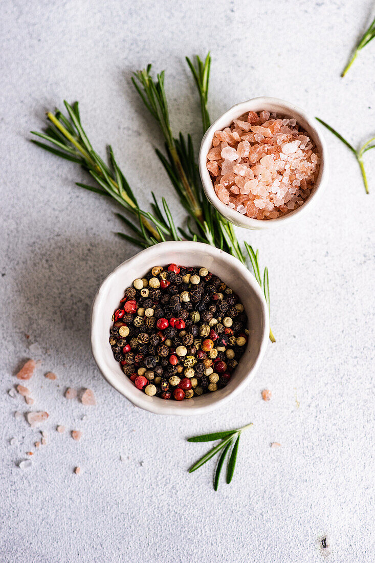 From above cooking concept with spices, olive oil and rosemary herb on concrete background