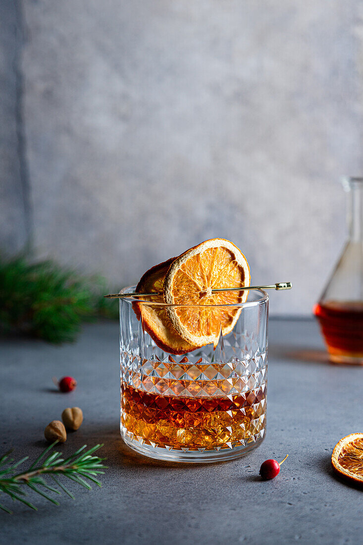 Composition of cold icy liquor garnished with orange slice and placed on table