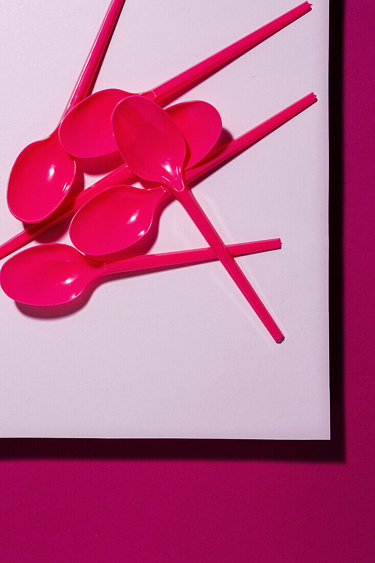 From above view of bright pink eco friendly spoon on pink carton background