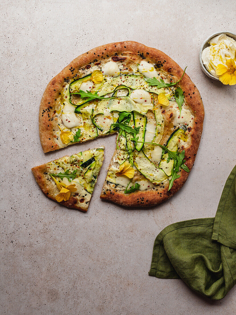 Top view of tasty pizza with arugula leaves on melted mozzarella cheese with black sesame seeds