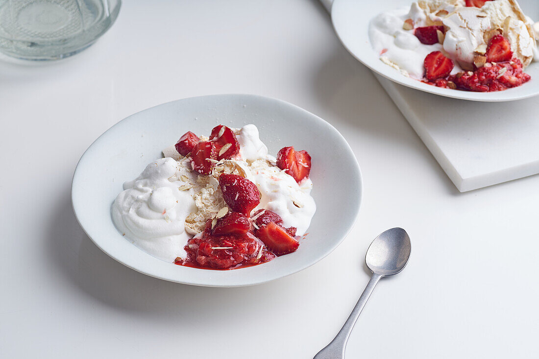 Eton's mess dessert with strawberries, crushed meringue and whipped cream