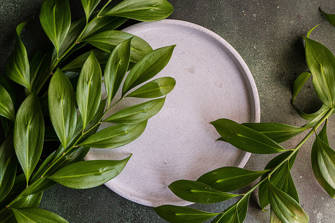 From above table setting with green italian ruscus leaves