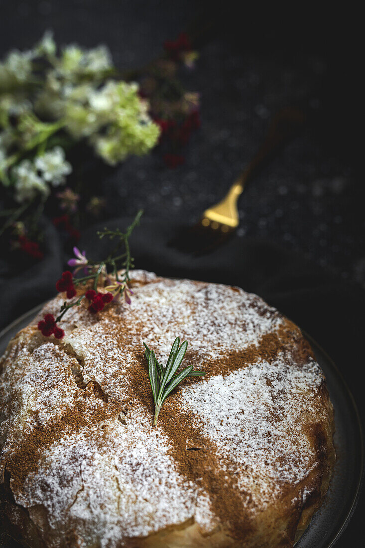 From above of appetizing bastilla with aromatic spices on table near flower sprig during Ramadan holidays