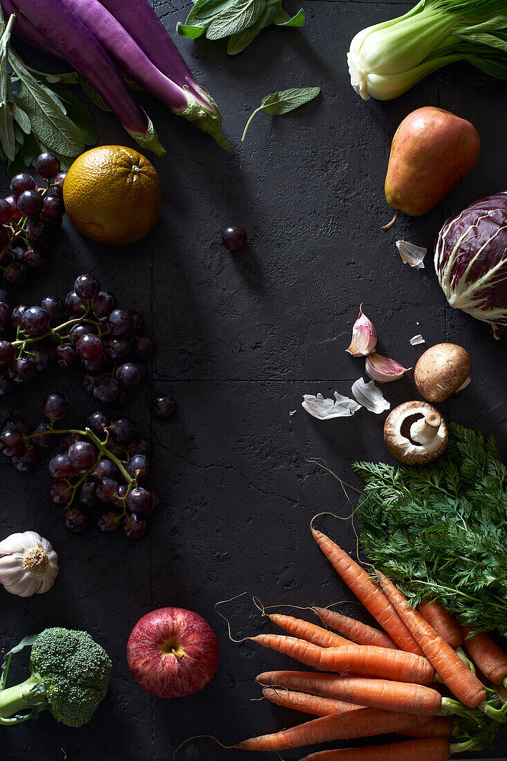 Food concept, flat lay with fresh fruits and vegetables on dark background