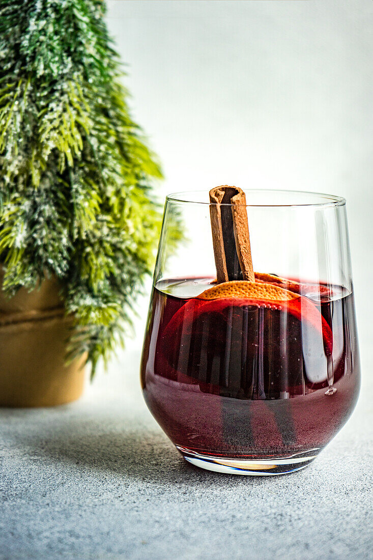 Winter mulled wine with spices on concrete background