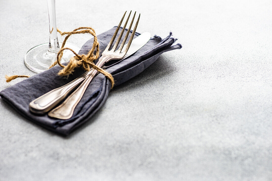 Minimalistic cutlery set on the concrete background