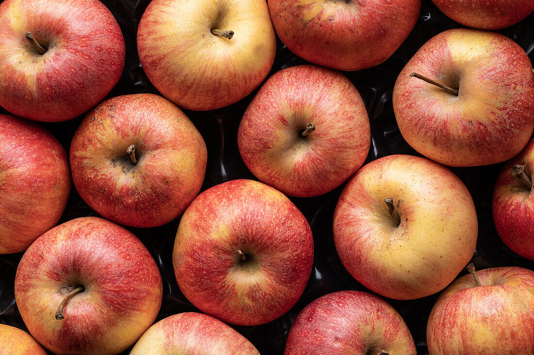 Top view full frame background of delicious fresh red apples composed together in rows