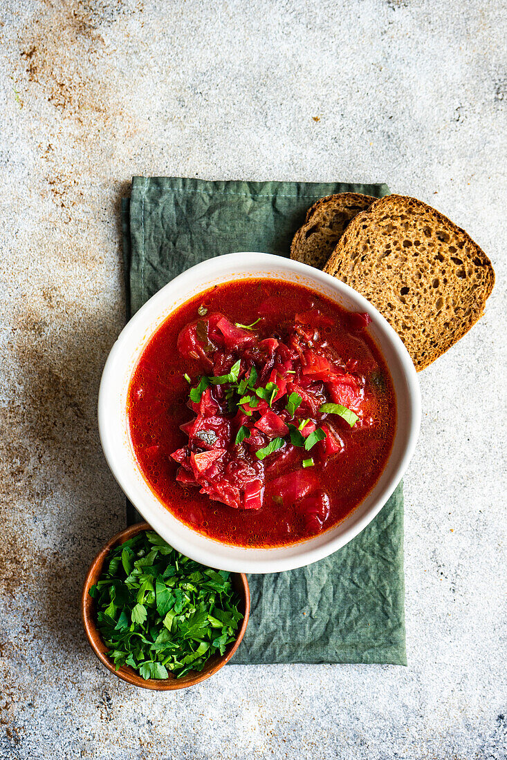 Tasty Ukrainian beetroot soup known as a Borscht served in the bowl on stone table