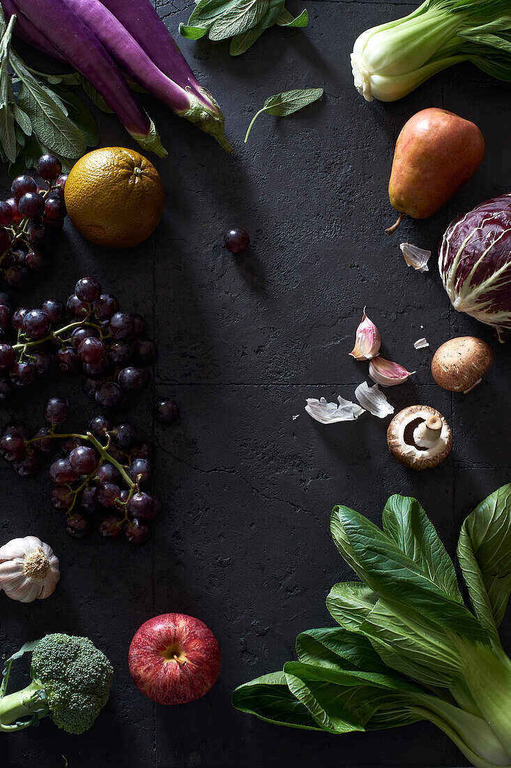 Food concept, flat lay with fresh fruits and vegetables on dark background