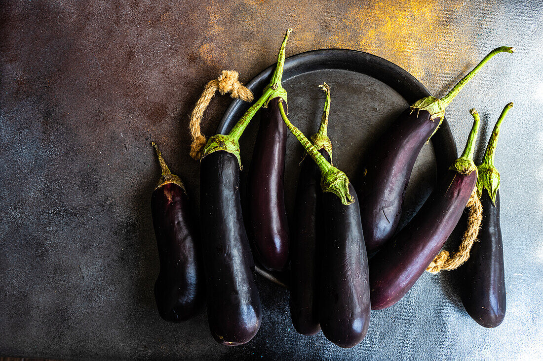 From above organic eggplants placed on dark table