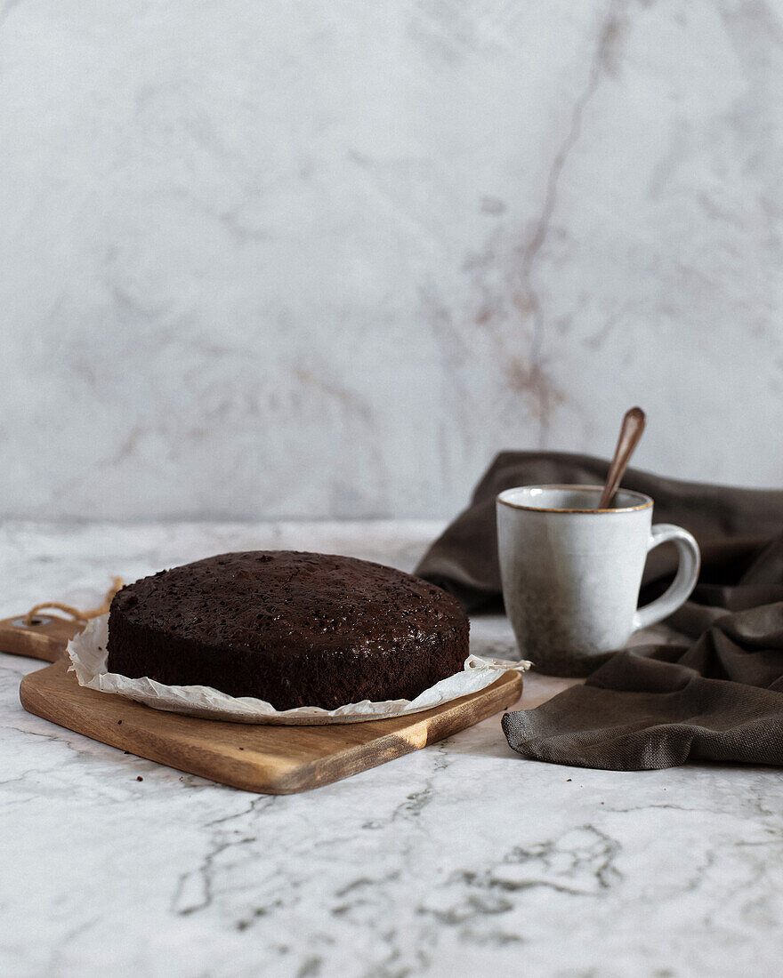 Front view brownie cake on a plate on white marble background