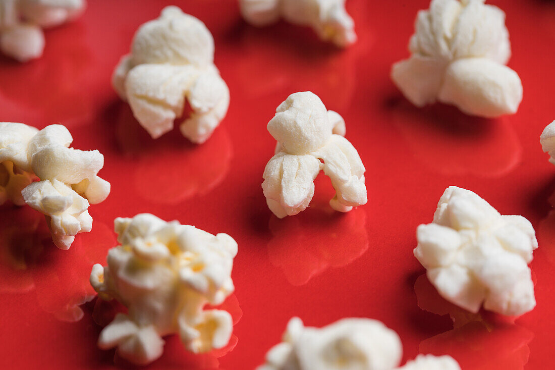 Closeup of some popcorn on a red background