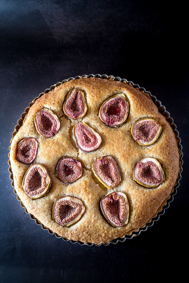 From above of sweet pie with figs served in baking dish on table
