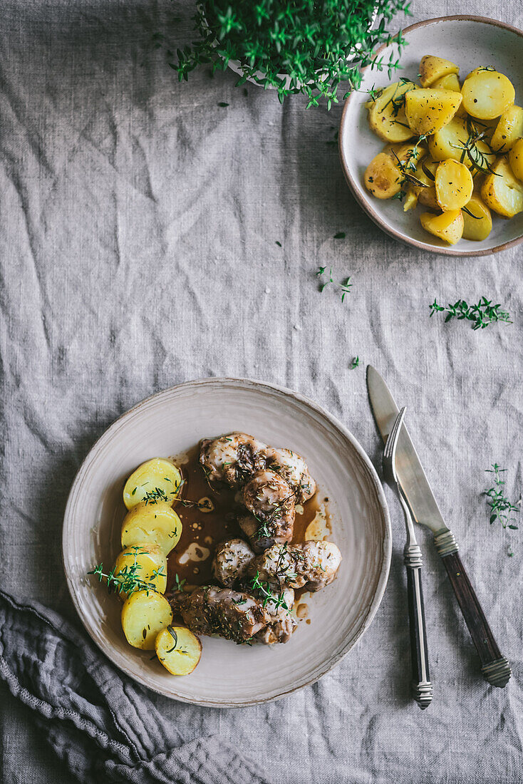 From above of appetizing stew with potatoes and rabbit meat served in plate on rustic table