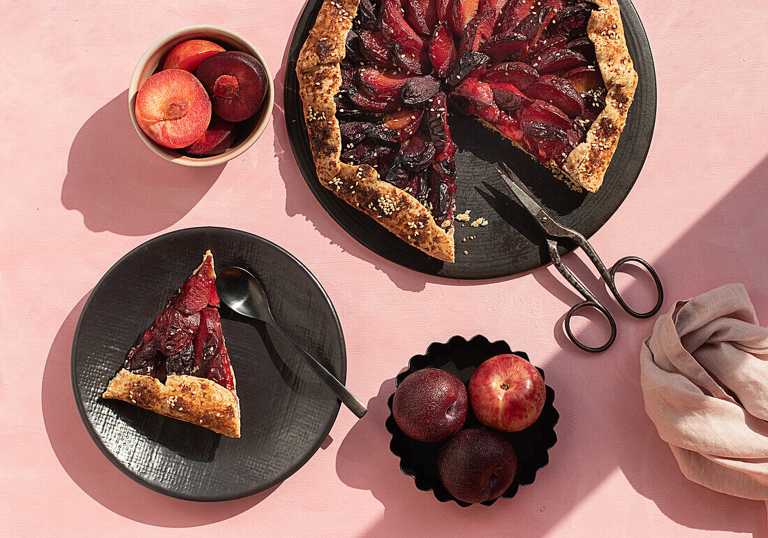 Close-up of a plum cake seen from above on a pink background