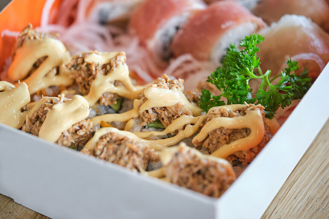 Stock photo of delicious box of sushi with special sauces.