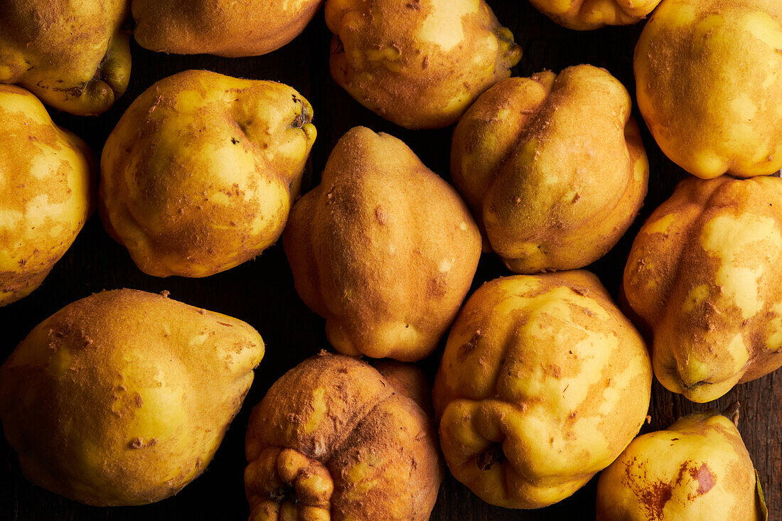 Top view of fresh whole sour yellow lemons on wooden background