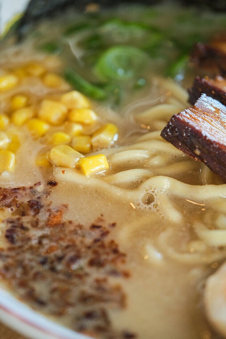 Stock photo of delicious noodle soup with boiled egg and meat in japanese restaurant.