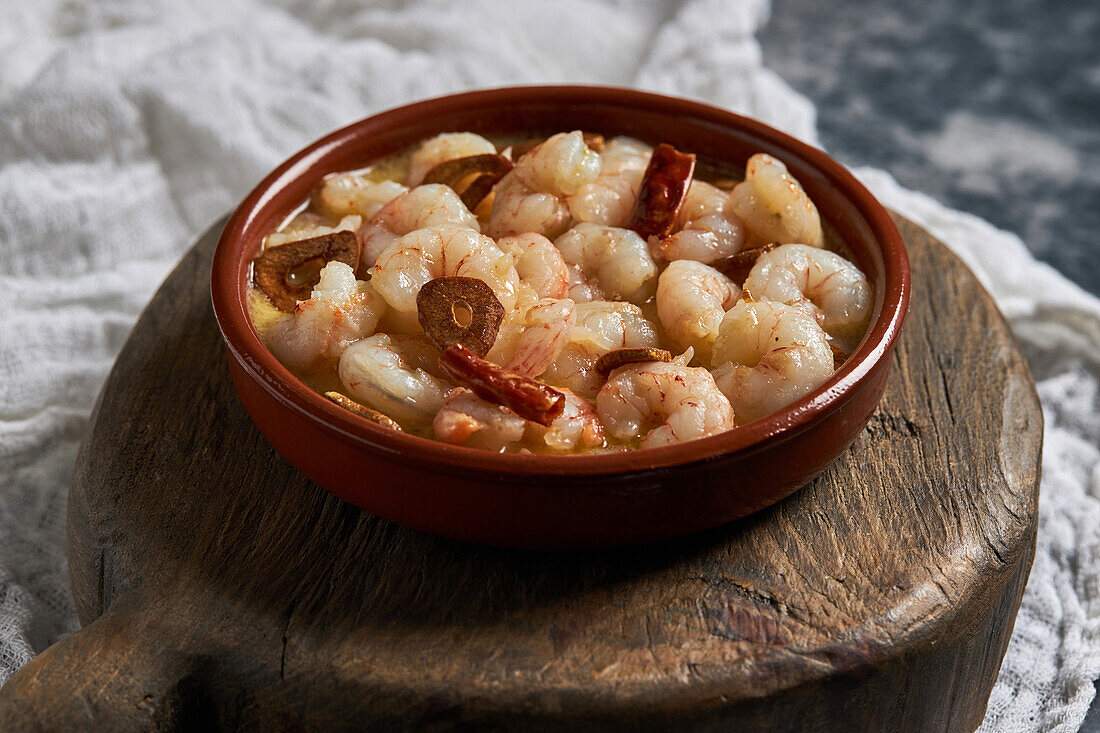 From above bowl of delicious prawn soup with chili peppers served on table in restaurant