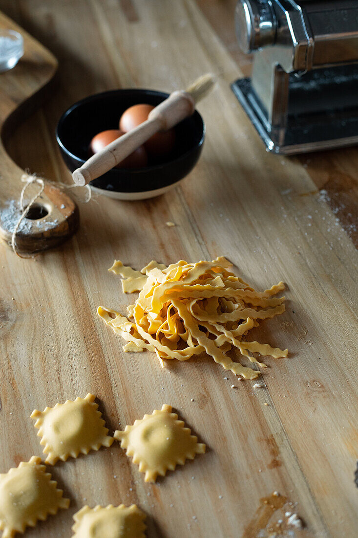 Unrecognizable person preparing raviolis and pasta at home