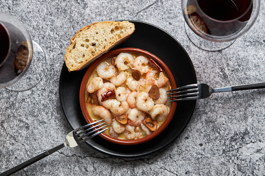 From above bowl of delicious prawn soup with chili peppers served on table in restaurant