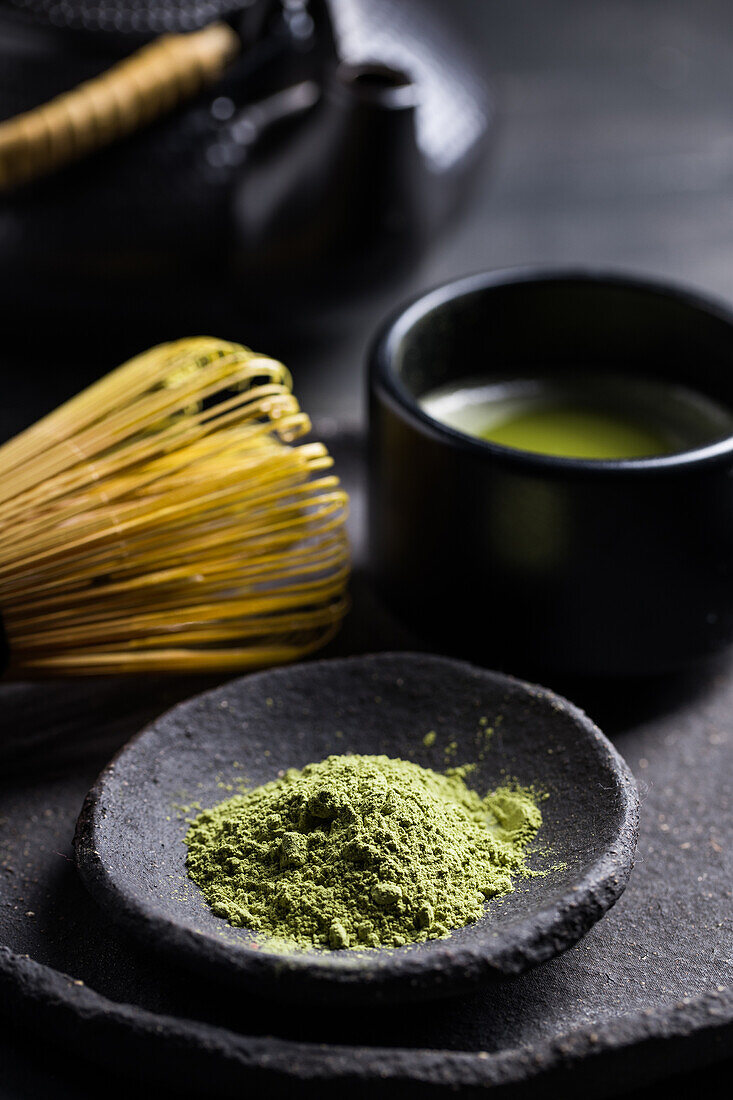 From above of traditional Japanese matcha with tea whisk in stone bowl for traditional oriental ceremony