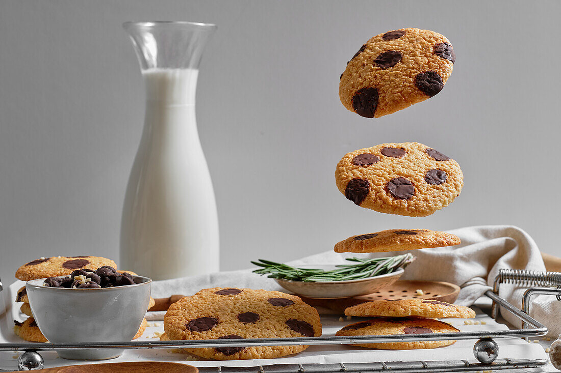 Delicious homemade sweet cookies with chocolate ships served on tray with glass jar of milk