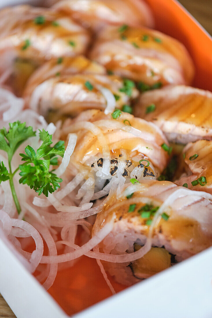 Stock photo of box full of different types of sushi in japanese restaurant.