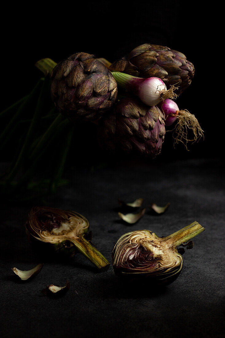 From above ripe green artichokes placed on black table background
